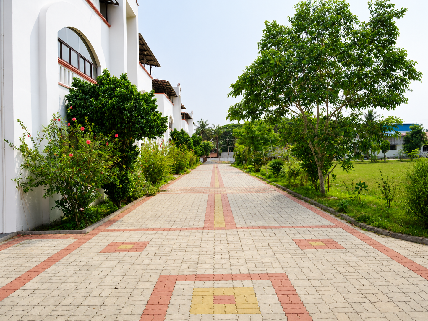 Tree-lined pathway leading to Hotel Sampoorna